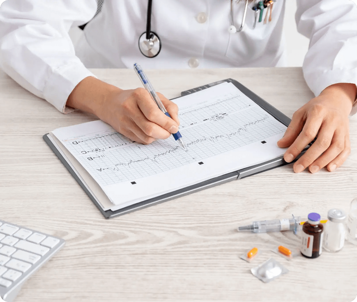Physician writing notes on patient records